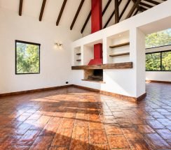 9Sunlit Rustic Living Space with Bold Red Chimney